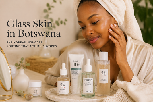Motswana woman with glowing clear skin following a Korean skincare routine with premium Korean skincare products in a warm minimalist beauty setting.